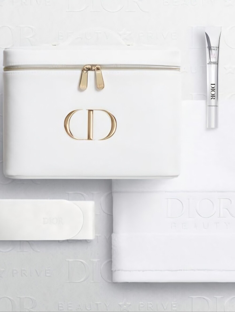 Dior white vanity case with gold CD logo, hairband, and face towel and Eye Cream
